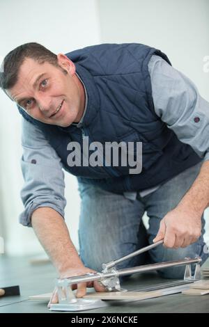 workman cutting ceramic tiles with handy machine Stock Photo