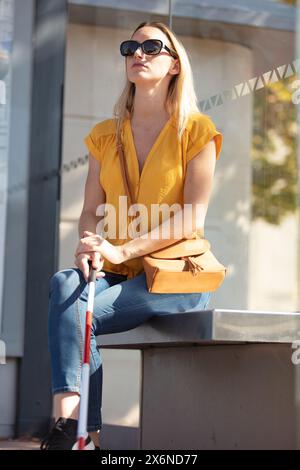 blind woman sitting on a bench Stock Photo