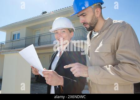 male and female civil engineers on construction site Stock Photo