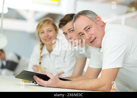 portrait of tutor and students on decorating course Stock Photo