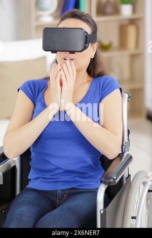 invalid woman in wheelchair using a vr mask Stock Photo