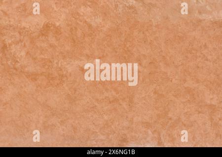 Texture of unevenly painted terracotta-colored plastered wall as abstract background. Stock Photo