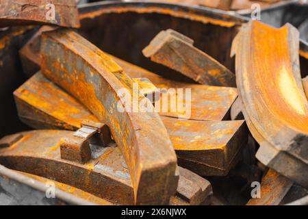 pile of rusty metal pieces used old part of train brake pad garbage rusted steel texture. Stock Photo