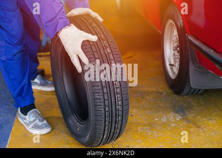 Wheel Tire change, Garage mechanic worker replace car tyre new rubber wheels in auto service workshop center Stock Photo