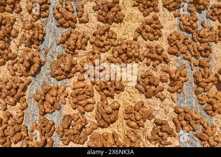 Africa Ginger root in Madagascar market, travel in Africa. Ginger on the cotton blanket on town shop market, Antanarivo in Madagascar. Stock Photo