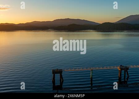 Pipeline with dock for industrial transport in harbour of Prince Rupert at sunset, British Columbia, Canada. Stock Photo