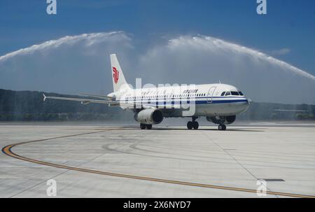 HANGZHOU, CHINA - MAY 16, 2024 - Flight CA726 from Osaka, Japan, passes through the 'water gate' set up at Hangzhou Xiaoshan International Airport to Stock Photo