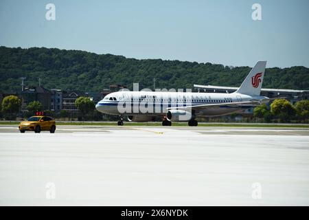 HANGZHOU, CHINA - MAY 16, 2024 - Flight CA726 from Osaka, Japan follows the guide car to the North Three Finger Corridor of the T4 Terminal of Hangzho Stock Photo