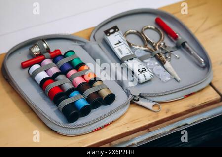 Sewing kit including colored thread, scissors, measuring tape, pins and needles Stock Photo