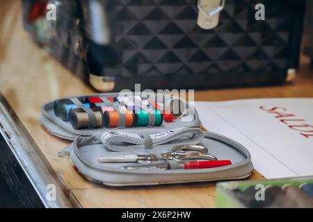 Sewing kit including colored thread, scissors, measuring tape, pins and needles Stock Photo