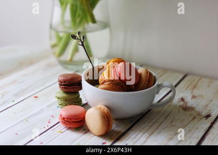 multi-colored macarons in a cup on the table  Stock Photo