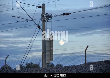 Detail of an AVE catenary with the moon in the background, near Puertollano Stock Photo