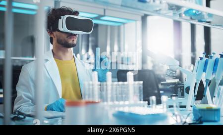 Futuristic Medical Research Laboratory: Research Scientist Wearing Virtual Reality Headset, Does Augmented Reality Research Using Smart Gestures. Big Data AI Biotechnology Research in Progress Stock Photo