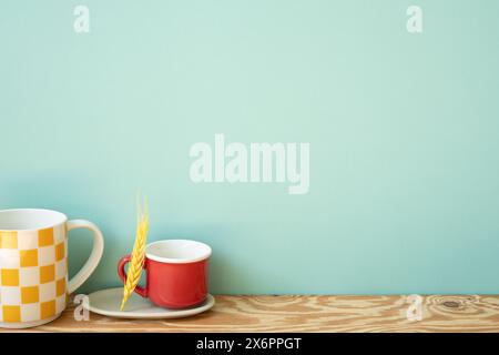 Empty mug cups on wooden shelf. mint wall background Stock Photo