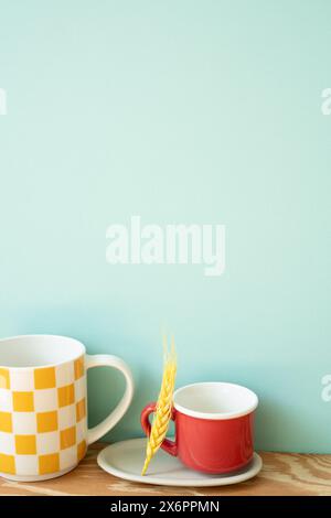 Empty mug cups on wooden shelf. mint wall background Stock Photo