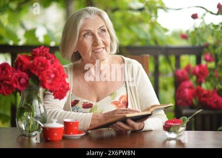 Close up portrait of beautiful senior woman with book Stock Photo