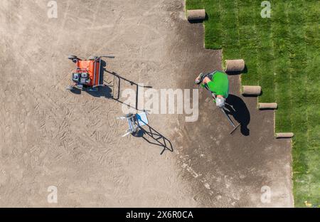 Aerial view of the gardener installing new grass turfs Stock Photo