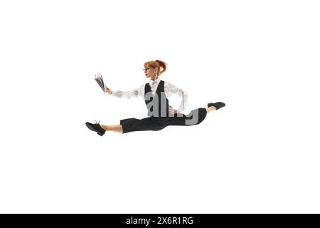 Focused woman in formal wear, manager jumping and looking on notes,preparing for project launching, isolated on white background. Stock Photo