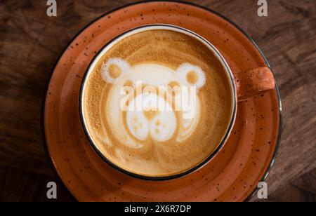Cappuccino foam art concept. Bear shaped figure made with foam milk on cappuccino drink. Stock Photo