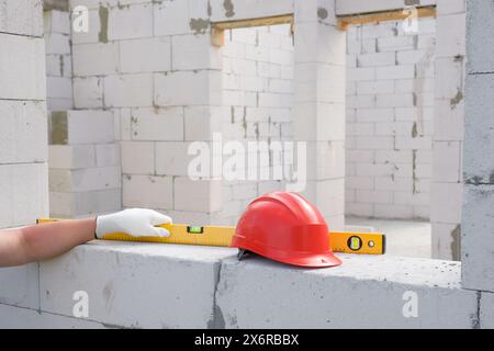 The hand of the builder measures the level of the plane using the building level. Construction concepts Stock Photo