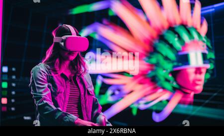 Digital Artist Using Virtual Reality 3D Software to Create a Beautiful Piece of Art in Interactive Creative Environment. Female Designer Using Virtual Reality Headset and Controllers for NFT Project. Stock Photo