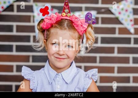 Cute preschooler girl makes art at a summer outdoor party Stock Photo