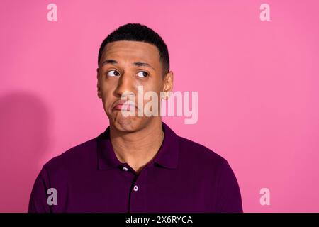 Photo portrait of nice young male look upset empty space dressed stylish violet garment isolated on pink color background Stock Photo
