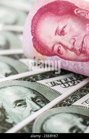 100 dollar banknotes with a hundred yuan note (Renminbi), concept of devaluation of the American currency against Chinese money, financial crisis Stock Photo