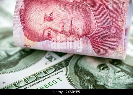 100 dollar banknotes with a hundred yuan note (Renminbi), concept of devaluation of the American currency against Chinese money, financial crisis Stock Photo