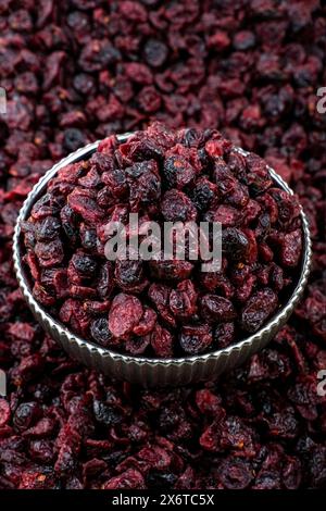 Close-Up View of Dried Cranberries in a Metal Bowl, A high-resolution image featuring a close-up view of dried cranberries. Stock Photo