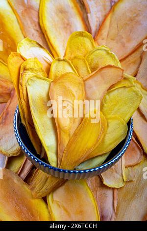 Close-Up of Dried Mango Slices in a Bowl Stock Photo