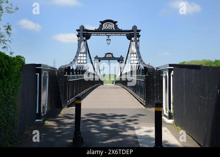 A view over the 1889 Victorian Ferry Bridge, a pedestrian suspension bridge over the River Trent in Burton upon Trent, Staffordshire, England.  The bi Stock Photo