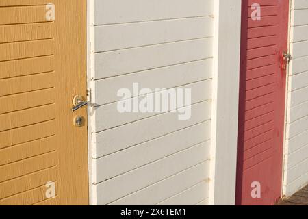 Old faded painted wooden surfaces. Door and door handle. Stock Photo