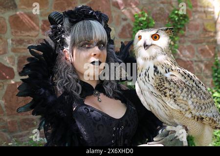 Fantasy figure. A woman dressed as a witch with an eagle owl on her hand Stock Photo