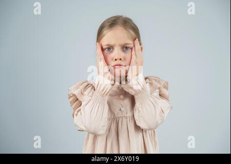 Portrait of a dissatisfied Caucasian girl on a white background.  Stock Photo