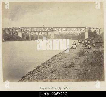 Bridge over the Brantas near Djadjar (title on object), State Railways on Java (series title), The construction of the bridge over the Brantas near Djadjar. In the foreground workers on the riverbank. Part of a group of 62 photos in a box with the inscription 'State Railways on Java' from 1888., photograph, Herman Salzwedel, (mentioned on object), Surabaya, 1880 - 1888, photographic support, albumen print, height c. 215 mm × width c. 275 mm, height c. 300 mm × width c. 370 mm Stock Photo