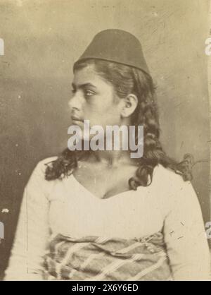 Portrait of an Arab girl with fez, Egypt, This photo is part of an album., photograph, anonymous, Egypte, 1890 - 1900, photographic support, albumen print, height, 123 mm × width, 94 mm Stock Photo