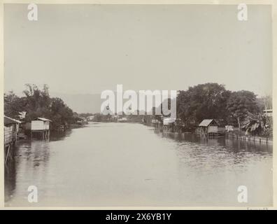 River with stilt houses in the Dutch East Indies, Part of Travel album with photos of sights in Italy, Switzerland and the Dutch East Indies., photograph, anonymous, Dutch East Indies, The, c. 1895 - c. 1905, paper, albumen print, height, 214 mm × width, 285 mm Stock Photo