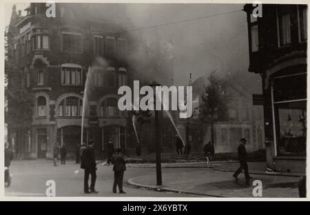 Extinguishing a fire, after the bombing, in the Infirmerstraat in Rotterdam, This photo is part of an album., photograph, J. Nolte, (attributed to), Rotterdam, c. 14-May-1940, photographic support, gelatin silver print, height, 89 mm × width, 140 mm Stock Photo