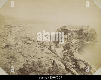 View of Monaco with the old fortified city on the right and a train station in the foreground, Panorama de la Principauté de Monaco (title on object), Part of Album by a French amateur with photos of France, Algeria, Palmyra, the World Exhibition of 1900 and of well-known French., photograph, Étienne Neurdein, Monaco, c. 1890 - c. 1900, paper, albumen print, height, 206 mm × width, 273 mm Stock Photo