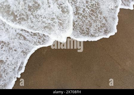 Soft wave of the sea on the sandy beach Stock Photo