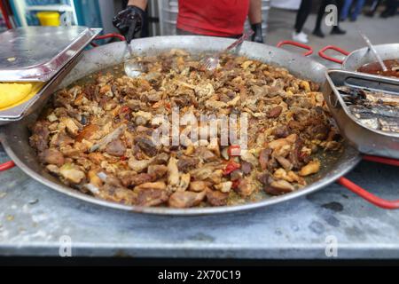 Romanian traditional meat stew being cooked in a huge pan at an outdoor food festival Stock Photo