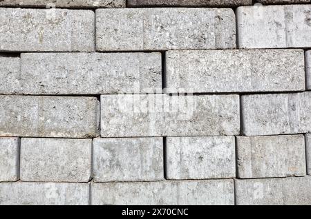 A closeup of a pile of stacked gray sand-lime bricks for building a house. Gray sand-lime brick Stock Photo