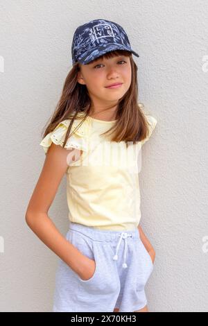 Eleven year old girl wearing a baseball cap Stock Photo