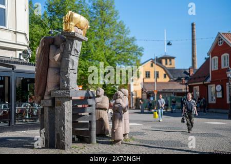 Skvallertorget or Gossip square with the golden calf on a granite sculpture by Pye Engström in Norrköping during spring in Sweden. Stock Photo