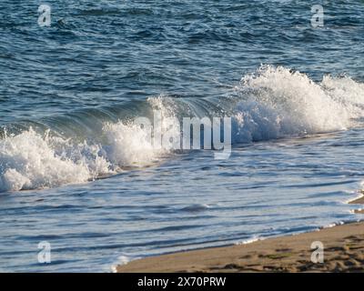 Beautiful curved water waves are used as a background image. Ocean wave. Spectacular aerial top background photo of white wave of ocean sea water spla Stock Photo