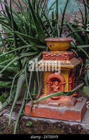 Hindu stone garden fountain with aloe vera plant in India, Maharashtra, Nashik. Stock Photo