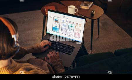 Young Handsome Men Working On Laptop Computer, Sitting on The Sofa in Stylish Loft Apartment. Creative Designer is Developing UX, UI for New Project, Preparing Presentation For the Clients. Stock Photo