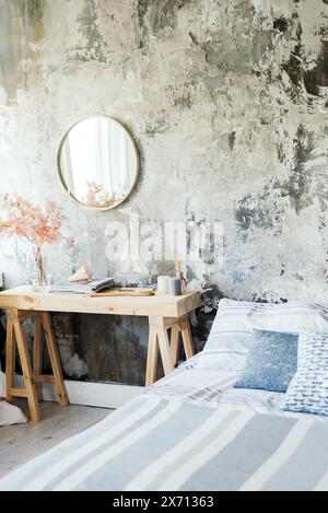 Beautiful and modern interior design of the hotel and bedroom. A grime mirror in a bedroom. loft wall. Boho style. Stock Photo