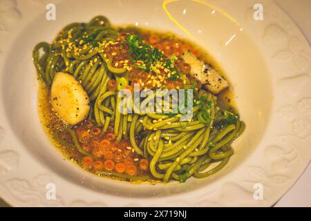 Ocha-infused Buckwheat Noodle Soba with Scallops and Truffle Sauce in a bowl Stock Photo